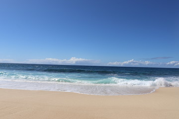 Fototapeta na wymiar The Banzai Pipeline surf reef break located in Hawaii at Ehukai Beach Park in Pupukea on Oahu North Shore