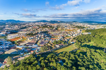 Top view aerial photo from flying drone of a Da Lat City with development buildings, transportation. Tourist city in developed Vietnam. Mai Anh Dao street, ward 8, near Love Valley park.
