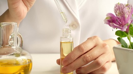 essential oil  made in the laboratory for natural organic skincare, cosmetic, aromatherapy , perfume, fragrance product and alternative medicine with the flower.