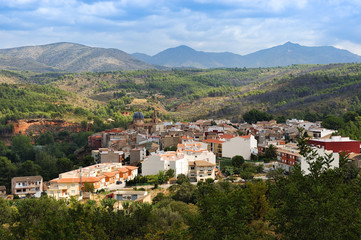 Fototapeta na wymiar view of the town of Navajas, in Castellon, with fields, mountains and clouds in the background