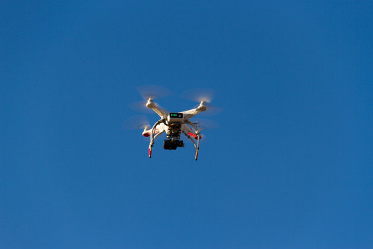 a drone that photographs flying in the blue sky