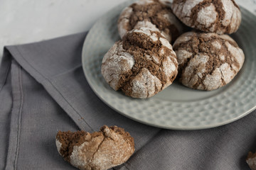 biscuits with chocolate cracks. Homemade tasty cookies in grey bowl on a table.