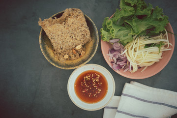 Crispy catfish spicy salad with sliced mango, shallot and lettuce