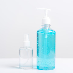 Plastic dispenser sanitizer alcohol gel pump and spray bottle for washing hand hygiene prevention of coronavirus virus studio shot on white background