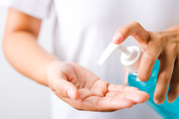 Closeup Hand Asian young woman applying pump dispenser sanitizer alcohol gel on hand wash cleaning, hygiene prevention COVID-19 or coronavirus protection concept, isolated on white background