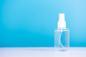 Plastic dispenser sanitizer alcohol spray bottle for washing hand hygiene prevention of coronavirus virus studio shot on blue background