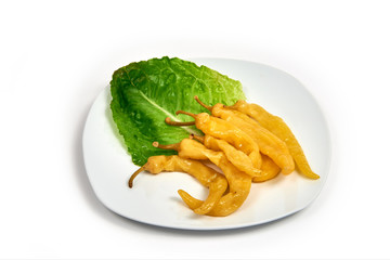 Braised pepper on a plate on white