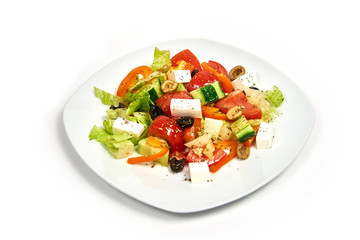 Plate with greek salad isolated on white background