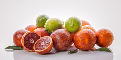 Food banner. Citrus fruits: red Sicilian orange and limes on a white background.