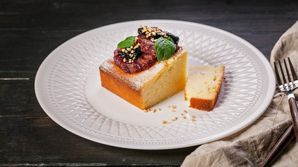 Food banner. Appetizing cake with strawberry jam on a white plate on a dark wooden table. Homemade baking. Cook at home