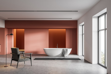 Orange and white bathroom, tub and armchair