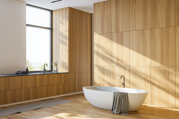 Luxury wooden bathroom corner with tub and sink