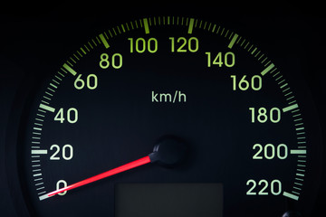Close-Up of a Glowing black car Speedometer with a red arrow indicating 0