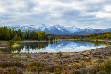 lake, Altai, Siberia, a cloudy autumn day. Taiga, beautiful sky, mountains