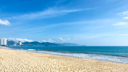 Wonderful beach in Nha Trang city. Palm trees, clear sea and long sandy beach. Vietnam. Beautiful seascape