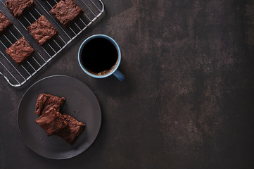 Brownies with Black coffee on dark table and Stainless cooking rack