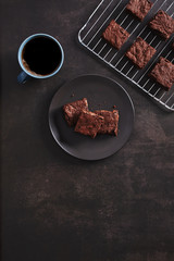 Brownies with Black coffee on dark table and Stainless cooking rack