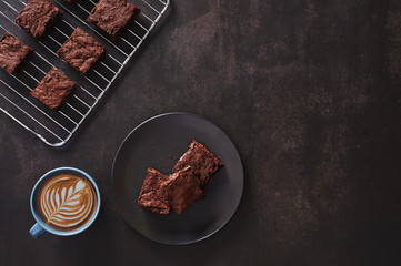 Brownies with Latte art on dark table and stainless cooking rack