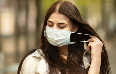 COVID-19 Pandemic Coronavirus Woman on city street wearing face mask protective for spreading of...