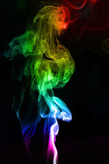 multicolored rainbow smoke on a black background