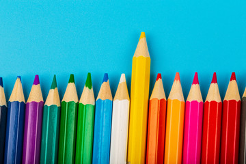 Close-up of set of colorful pencils on blue background with copy space