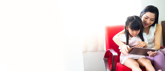 Happy mother and daughter using the laptop at home. Stay at Home. business, career, shopping online. Lifestyle concept