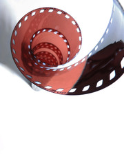 35mm film in the form of a spiral, transparent, on a white background.