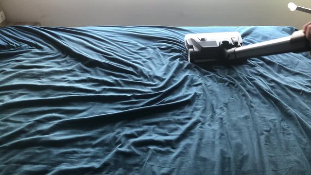 Mite vacuum cleaner Cleaning bed mattress dust eliminator, Dry cleaning removing dirt from bedroom, Concept of cleaning in house.