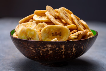 Healthy snack, crispy dehydrated unsugared banana chips in bowl