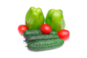 Organic, raw vegetables isolated. Green sweet pepper, tomatoes and cucumbers isolated on a white background.