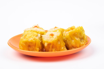 Siu Mai - Chinese steamed pork dumplings on plate isolated on white background.