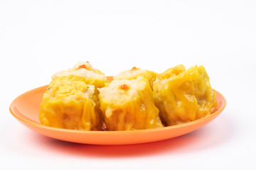 Siu Mai - Chinese steamed pork dumplings on plate isolated on white background.