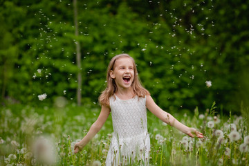 The girl is playing outdoors and having fun. The concept of pollen Allergy, spring, copy space.