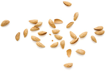 Roasted almonds in peel, scattered on a white background, close up, top view, isolated