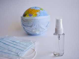A standard face mask on a globe model. Corona virus concept. Medical face mask for stopping the...