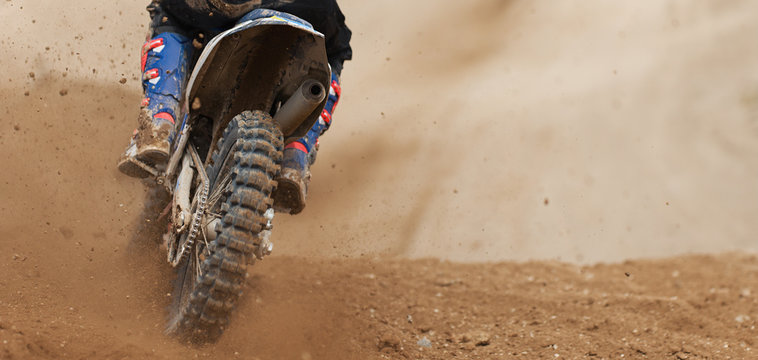 Motocross racer accelerating speed in track, driving in the motocross race