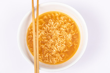 A bowl of cooked instant noodle curry taste on white background.