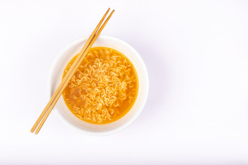 A bowl of cooked instant noodle curry taste on white background.