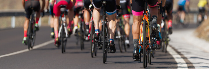 Fototapeta na wymiar Cycling competition,cyclist athletes riding a race, the peloton climbing the mountain