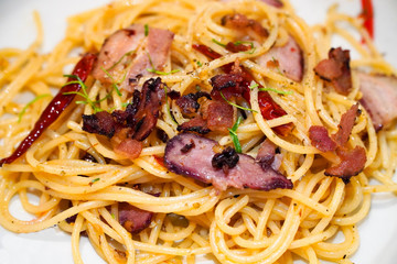 Spaghetti aglio e olio, Traditional Italian Pasta with dried chilli, garlic, olive oil and crispy bacon flakes on top
