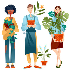 Young man and two women hold potted house plants.