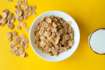 Breakfast ingredients. Cereals with milk. Top view, A bowl of corn flakes and raisins