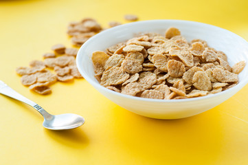 Breakfast ingredients. Cereals with milk. Top view, A bowl of corn flakes and raisins