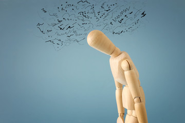 concept image of wooden dummy with worried stressed thoughts. depression, obsessive compulsive, adhd, anxiety disorders concept