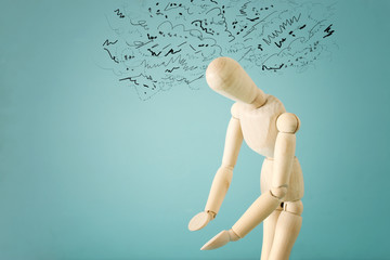 concept image of wooden dummy with worried stressed thoughts. depression, obsessive compulsive, adhd, anxiety disorders concept