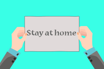 Two hands hold a placard that says Stay home.