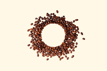 Circle frame of roasted brown coffee beans isolated on white background may use as background or texture.