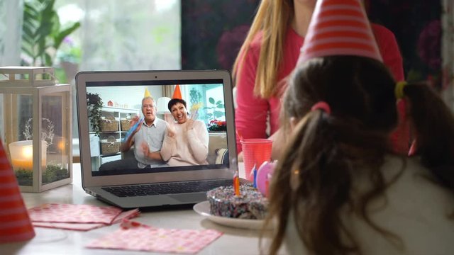 Happy Grandpa and Grandma Congratulate their Grandchildren Happy Birthday Using Laptop Video Call. Social distancing, self isolation during quarantine