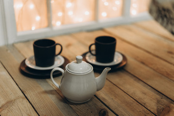 Fototapeta na wymiar white tea pot on wooden background