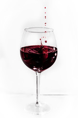 drops of red wine in a glass